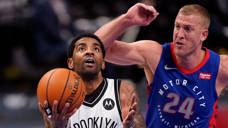 Brooklyn Nets guard Kyrie Irving (11) attempt a layup as Detroit Pistons center Mason Plumlee (24) defends during the first half of an NBA basketball game, Tuesday, Feb. 9, 2021, in Detroit.