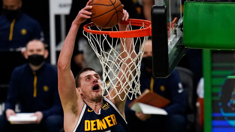 Denver Nuggets center Nikola Jokic (15) slams a dunk against the Boston Celtics during the first half of an NBA basketball game, Tuesday, Feb. 16, 2021, in Boston. 