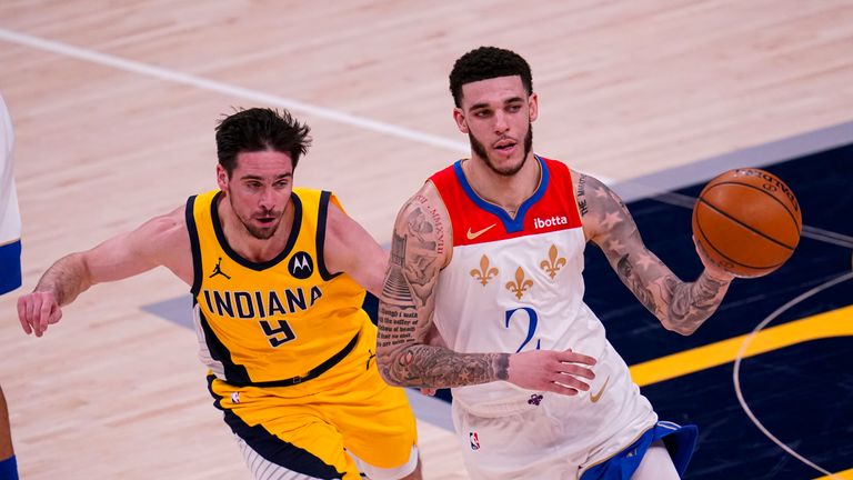 New Orleans Pelicans guard Lonzo Ball (2) drives past Indiana Pacers guard T.J. McConnell (9) during the second half of an NBA basketball game in Indianapolis, Friday, Feb. 5, 2021. The Pelicans defeated the Pacers 114-113. (AP Photo/Michael Conroy)


