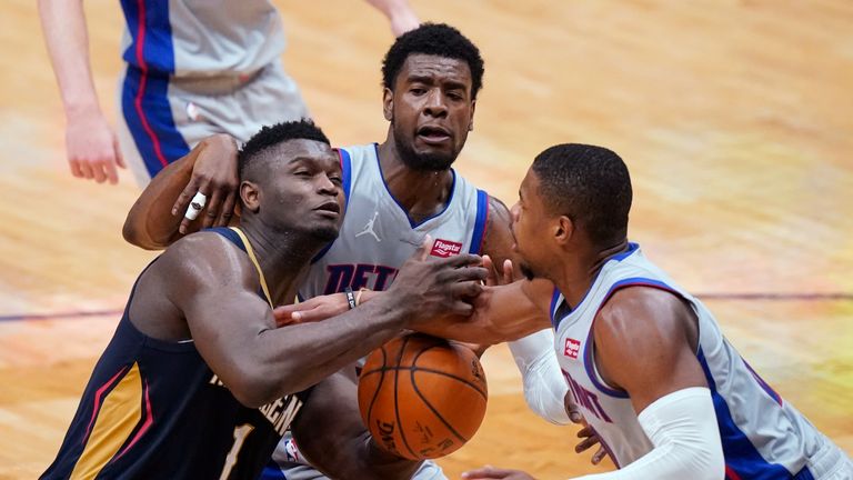 New Orleans Pelicans forward Zion Williamson (1) is fouled as he goes to the basket against Detroit Pistons guards Dennis Smith Jr., middle, and Josh Jackson during the second half of an NBA basketball game in New Orleans, Wednesday, Feb. 24, 2021. (AP Photo/Gerald Herbert)


