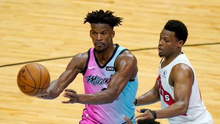 Miami Heat forward Jimmy Butler, left, passes as Toronto Raptors guard Kyle Lowry defends during the second half of an NBA basketball game, Wednesday, Feb. 24, 2021, in Miami. (AP Photo/Lynne Sladky)


