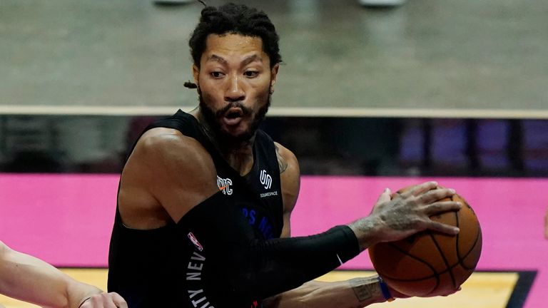 New York Knicks guard Derrick Rose looks to pass the ball as Miami Heat guard Duncan Robinson (55) defends during the first half of an NBA basketball game, Tuesday, Feb. 9, 2021, in Miami.