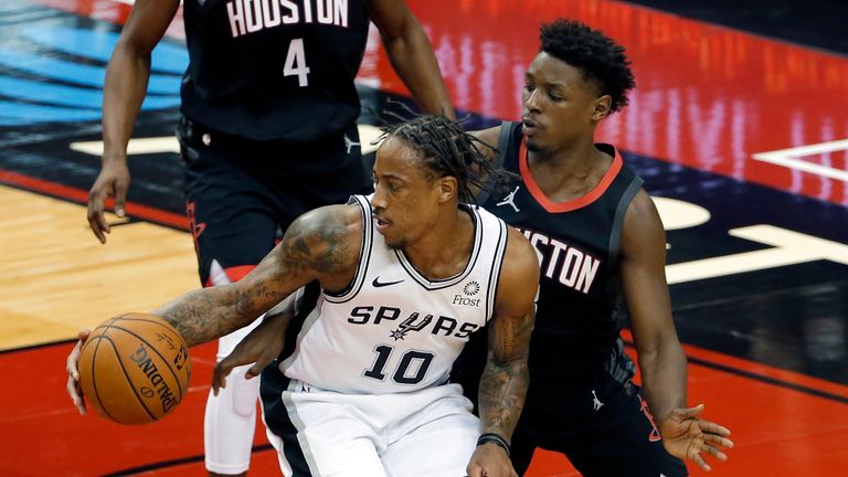 San Antonio Spurs forward DeMar DeRozan (10) drives to the basket in front of Houston Rockets forward Jae&#39;Sean Tate, right, during the first half of an NBA basketball game Saturday, Feb. 6, 2021, in Houston. (AP Photo/Michael Wyke)


