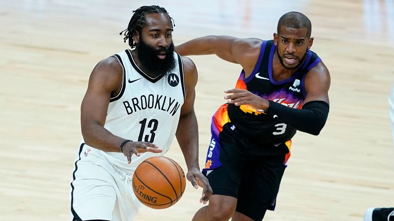 Brooklyn Nets guard James Harden (13) drives as Phoenix Suns guard Chris Paul (3) defends during the first half of an NBA basketball game Tuesday, Feb. 16, 2021, in Phoenix.