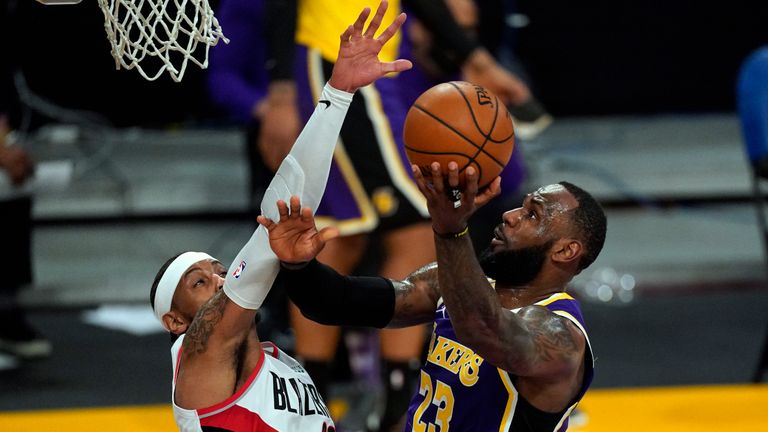 Los Angeles Lakers forward LeBron James (23) takes a shot against Portland Trail Blazers forward Carmelo Anthony (00) during the first half of an NBA basketball game Friday, Feb. 26, 2021, in Los Angeles. (AP Photo/Mark J. Terrill)


