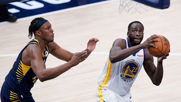 Golden State Warriors&#39; Draymond Green (23) looks for a shot next to Indiana Pacers&#39; Myles Turner during the second half of an NBA basketball game Wednesday, Feb. 24, 2021, in Indianapolis. (AP Photo/Darron Cummings)


