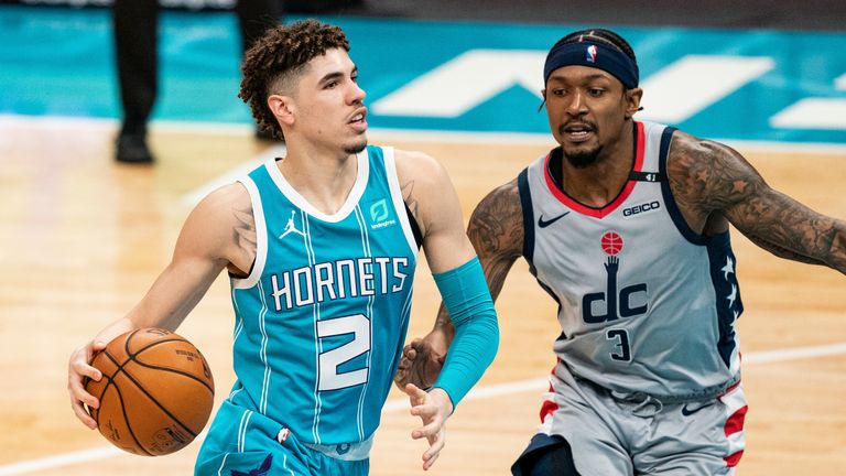 Charlotte Hornets guard LaMelo Ball (2) drives to the basket while guarded by Washington Wizards guard Bradley Beal (3) during the second half of an NBA basketball game in Charlotte, N.C., Sunday, Feb. 7, 2021. (AP Photo/Jacob Kupferman)


