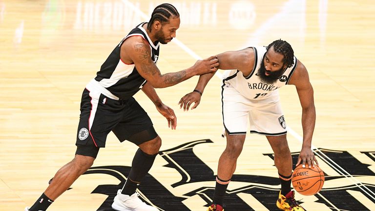 Brooklyn Nets Guard James Harden is guarded closely by Los Angeles Clippers Forward Kawhi Leonard