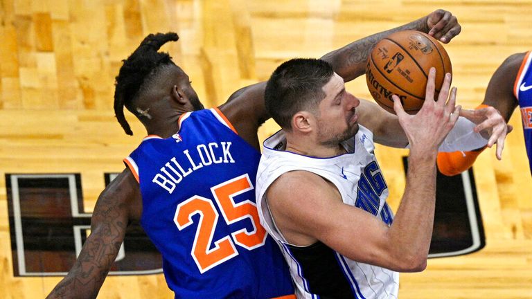 AP - New York Knicks forward Reggie Bullock (25) defends against Orlando Magic center Nikola Vucevic