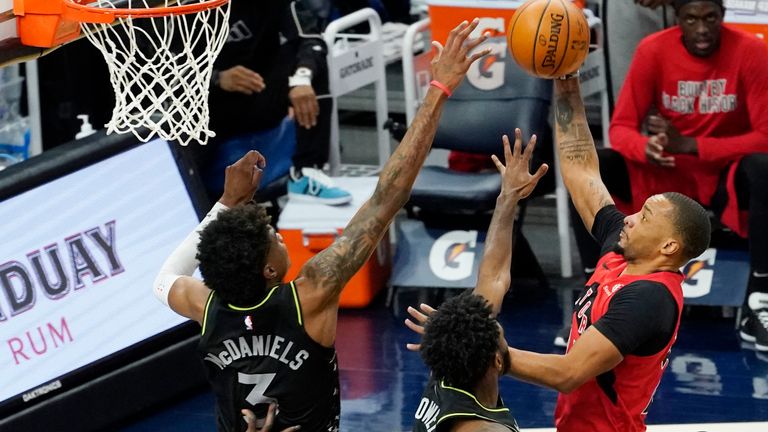 Toronto Raptors&#39; Norman Powell lays up as he is double-teamed by Minnesota Timberwolves&#39; Jaden McDaniels and Jaylen Nowell