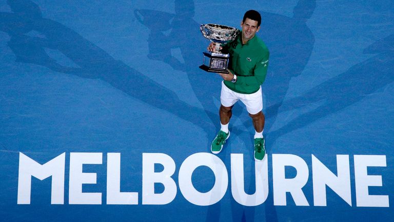 Serbia's Novak Djokovic holds the Norman Brookes Challenge Cup after defeating Austria's Dominic Thiem in the men's singles final of the Australian Open tennis championship in Melbourne, Australia. 