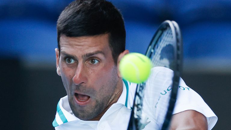 Novak Djokovic makes a backhand return to United States' Frances Tiafoe during their second round match at the Australian Open tennis championship in Melbourne, Australia, Wednesday, Feb. 10, 2021.(AP Photo/Rick Rycroft)