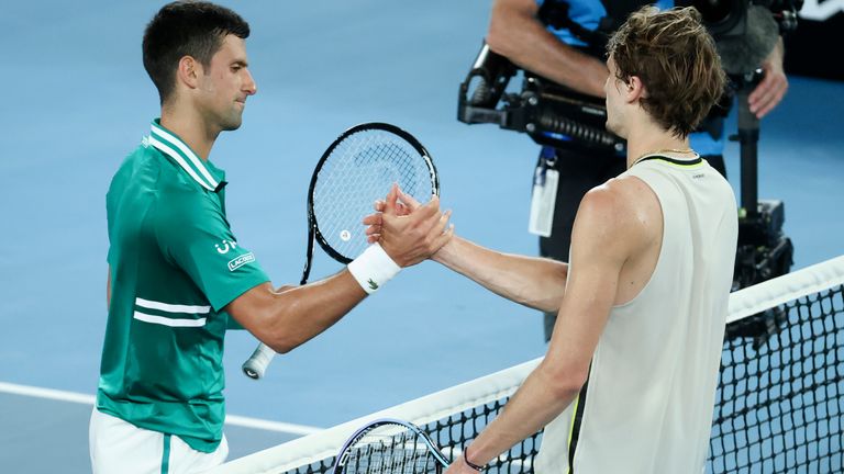 Serbia's Novak Djokovic, left, is congratulated by Germany's Alexander Zverev after winning their quarterfinal match at the Australian Open tennis championship in Melbourne, Australia, Wednesday, Feb. 17, 2021.(AP Photo/Hamish Blair)