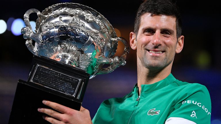 Serbia's Novak Djokovic holds the Norman Brookes Challenge Cup after defeating Russia's Daniil Medvedev in the men's singles final at the Australian Open tennis championship in Melbourne, Australia, Sunday, Feb. 21, 2021.(AP Photo/Andy Brownbill)