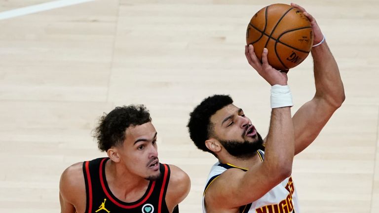 Denver Nuggets guard Jamal Murray is fouled by Atlanta Hawks guard Trae Young