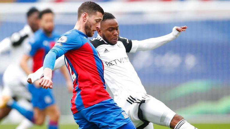 Crystal Palace's Joel Ward, left, and Fulham's Ademola Lookman challenge for the ball