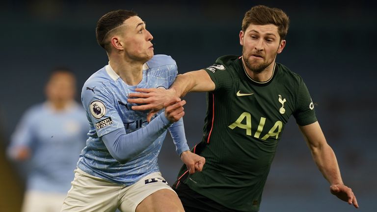 Phil Foden vies for the ball with Ben Davies