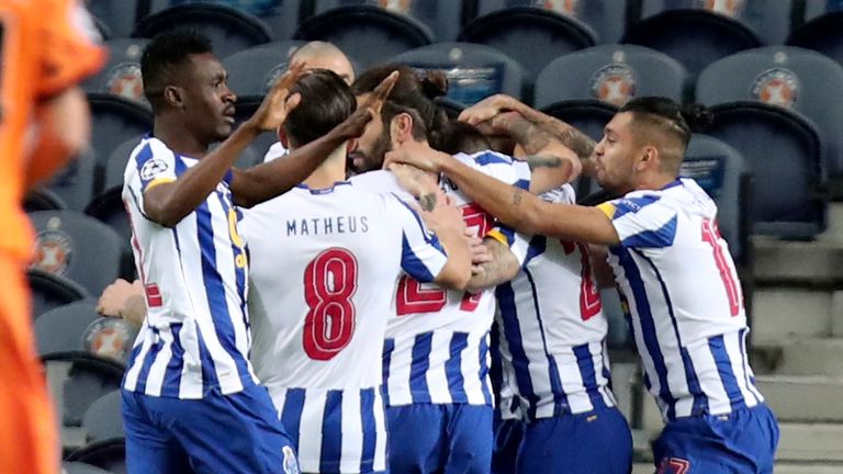 Porto players celebrate after Porto&#39;s Mehdi Taremi scored the opening goal during the Champions League round of 16, first leg, soccer match between FC Porto and Juventus at the Dragao stadium in Porto, Portugal, Wednesday, Feb. 17, 2021. (AP Photo/Luis Vieira)