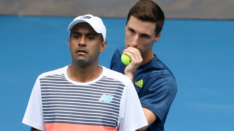 Rajeev Ram, left, of the US and Britain's Joe Salisbury chat during their match against Croatia's Ivan Dodig and Slovakia's Filip Polasek in the men's doubles final at the Australian Open tennis championship in Melbourne, Australia, Sunday, Feb. 21, 2021.(AP Photo/Hamish Blair)