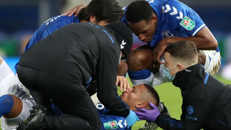 Richarlison receives attention from medical staff after a head collision