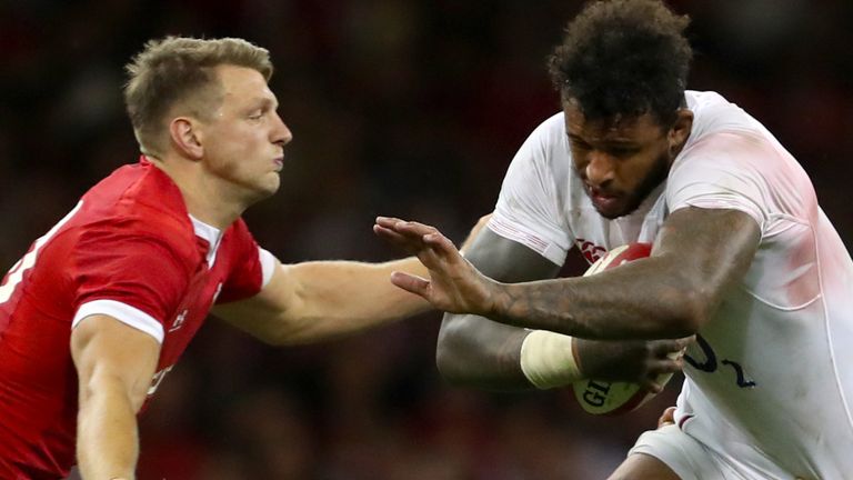 Courtney Lawes (centre) is tackled by Wales' Dan Biggar and Aaron Shingler in 2019