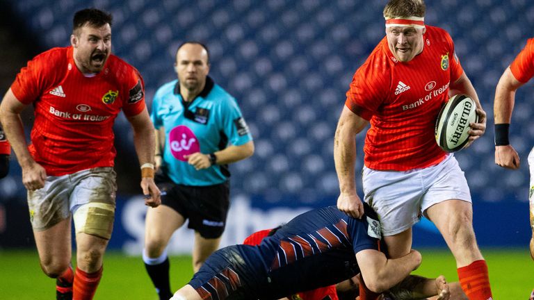 John Ryan of Munster is tackled by Luke Crosbie of Edinburgh