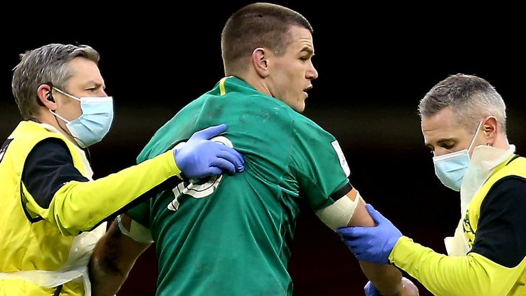 Jonathan Sexton is attended to by Ireland team physio Keith Fox, left, and team doctor Dr Ciaran Cosgrave