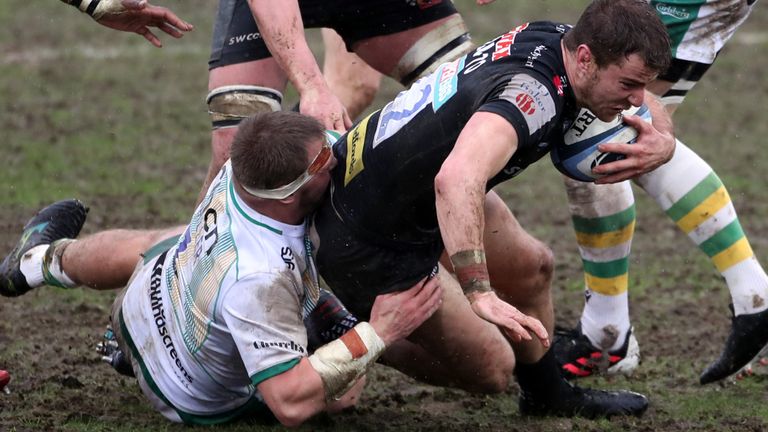 Ollie Devoto is tackled by Northampton Saints prop Alex Waller