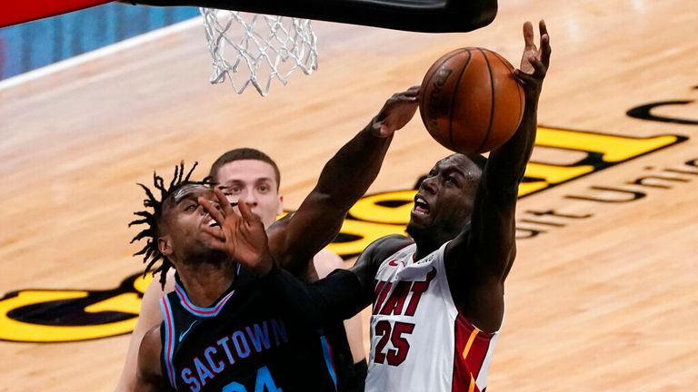 AP - Sacramento Kings guard Buddy Hield, left, blocks the shot of Miami Heat guard Kendrick Nunn 