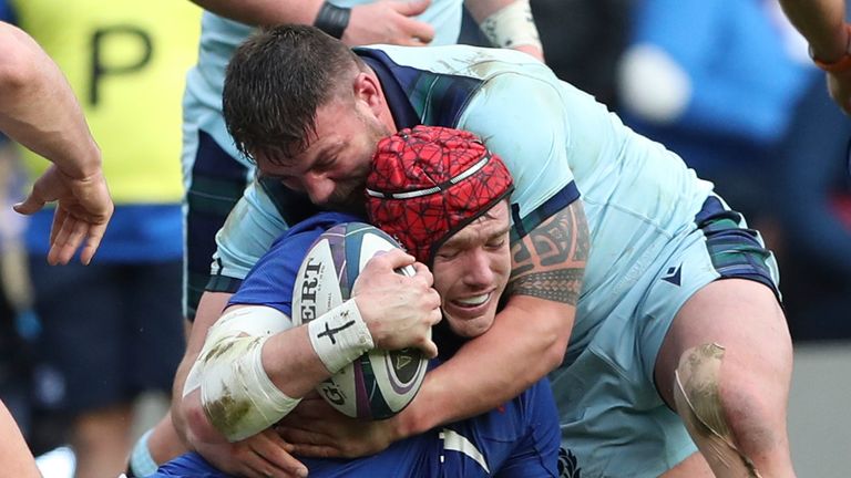 Scotland's Rory Sutherland, right, tackles France's Bernard le Roux during the Six Nations rugby union international match between Scotland and France at the Murrayfield stadium in Edinburgh, Scotland, Sunday, March 8, 2020. (AP Photo/Scott Heppell)