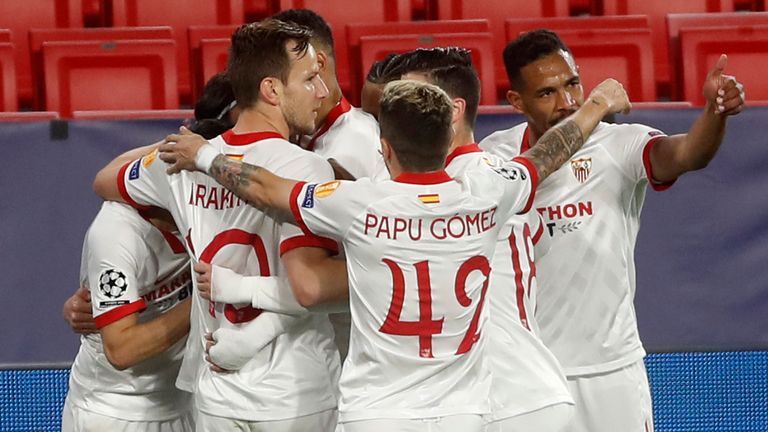 Sevilla players celebrate after Suso scored his side&#39;s opening goal during the Champions League, round of 16, first leg soccer match between Sevilla and Borussia Dortmund at the Ramon Sanchez Pizjuan stadium in Seville, Spain, Wednesday, Feb. 17, 2021. (AP Photo/Angel Fernandez)