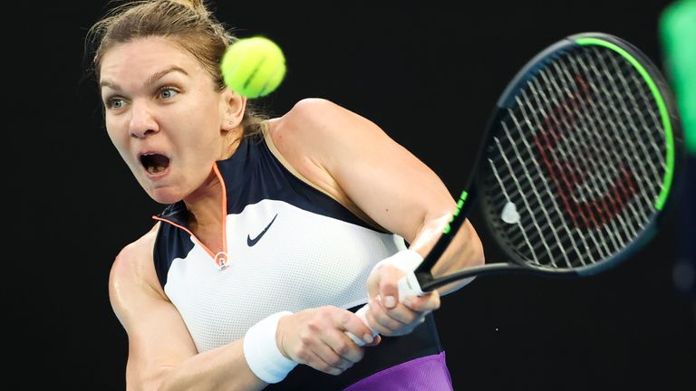 Simona Halep hits a backhand return to United States' Serena Williams during their quarterfinal match at the Australian Open tennis championship in Melbourne, Australia, Tuesday, Feb. 16, 2021.(AP Photo/Hamish Blair)