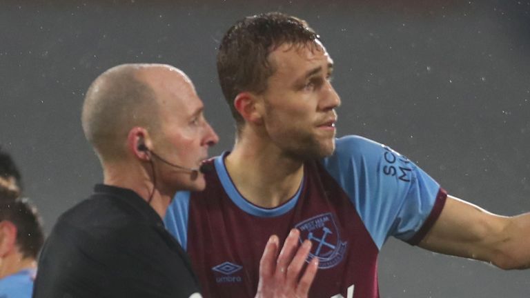 West Ham&#39;s Tomas Soucek, center, talks to the referee after he was shown a red card during the English Premier League match between Fulham and West Ham at the Craven Cottage stadium in London, Saturday, Feb. 6, 2021. (Clive Rose/Pool via AP)