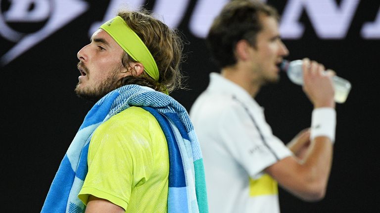 Greece's Stefanos Tsitsipas walks past Russia's Daniil Medvedev during their semifinal matchat the Australian Open tennis championship in Melbourne, Australia, Friday, Feb. 19, 2021.(AP Photo/Andy Brownbill)