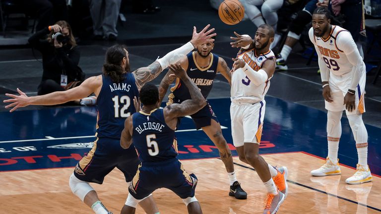 Phoenix Suns guard Chris Paul passes as New Orleans Pelicans center Steven Adams and guard Eric Bledsoe defend