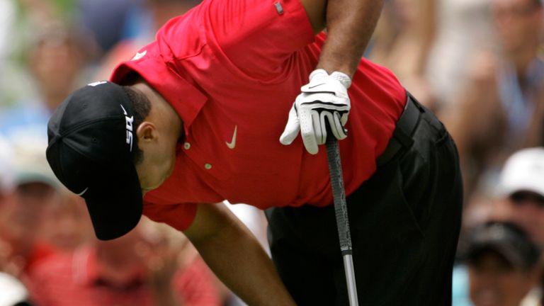 Tiger Woods holds on to his left knee after teeing off on the second hole during the fourth round of the US Open championship at Torrey Pines Golf Course on Sunday, June 15, 2008 in San Diego.  (AP Photo/Charlie Riedel)