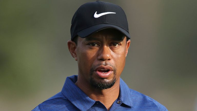 In this Thursday, Feb. 2, 2017 photo, Tiger Woods reacts on hole 10th during the 1st round of the Dubai Desert Classic golf tournament in Dubai, United Arab Emirates. Tiger Woods has withdrawn from the Dubai Desert Classic with an apparent back injury after shooting an opening-round 5-over 77.(AP Photo/Kamran Jebreili)
