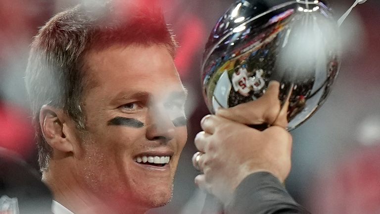 Tampa Bay Buccaneers quarterback Tom Brady looks at the Vince Lombardi trophy after defeating the Kansas City Chiefs in the NFL Super Bowl 55 football game Sunday, Feb. 7, 2021, in Tampa, Fla. The Buccaneers defeated the Chiefs 31-9 to win the Super Bowl. (AP Photo/David J. Phillip)