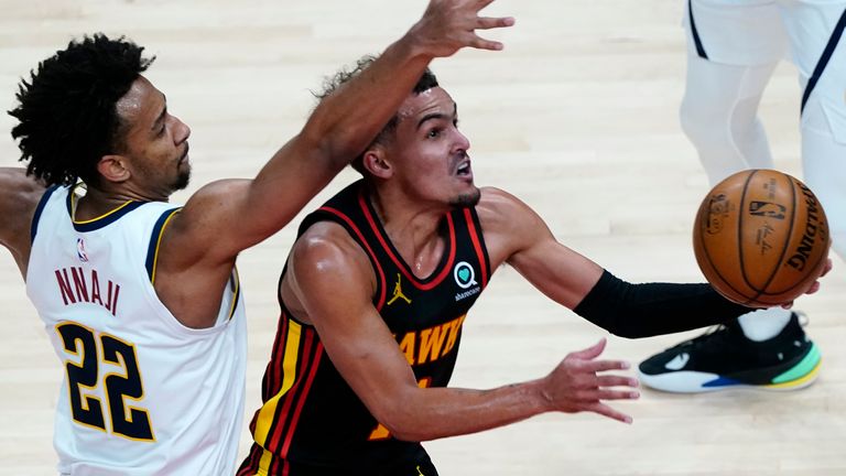 Atlanta Hawks guard Trae Young goes past Denver Nuggets forward Zeke Nnaji