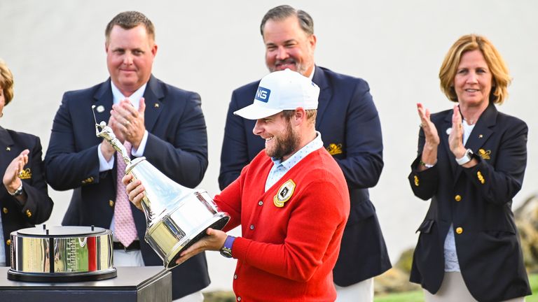 Tyrrell Hatton of England smiles as he holds the trophy following his one stroke victory in the final round of the Arnold Palmer Invitational presented by MasterCard at Bay Hill Club and Lodge on March 8, 2020 in Orlando, Florida. (Photo by Keyur Khamar/PGA TOUR via Getty Images)