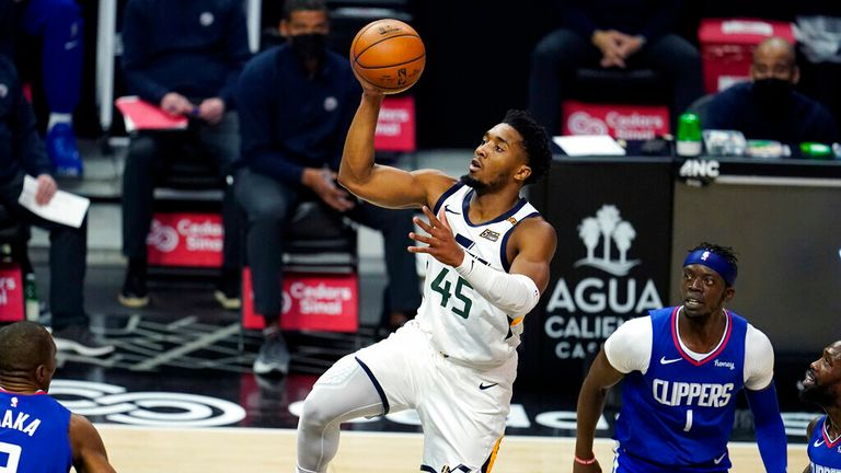 AP - Utah Jazz guard Donovan Mitchell (45) shoots past Los Angeles Clippers guard Reggie Jackson (1)