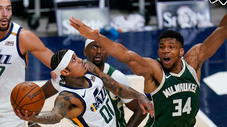 AP - Utah Jazz guard Jordan Clarkson (00) goes to the basket as  forward Giannis Antetokounmpo (34) defends 