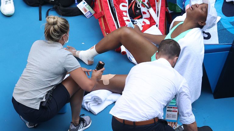 Venus Williams reacts as she receives treatment to leg injuries during her second round match against Italy's Sara Errani at the Australian Open tennis championship in Melbourne, Australia, Wednesday, Feb. 10, 2021.(AP Photo/Hamish Blair)