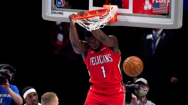 AP - New Orleans Pelicans' Zion Williamson (1) dunks as Dallas Mavericks' Josh Richardson, bottom left, and Kristaps Porzingis 