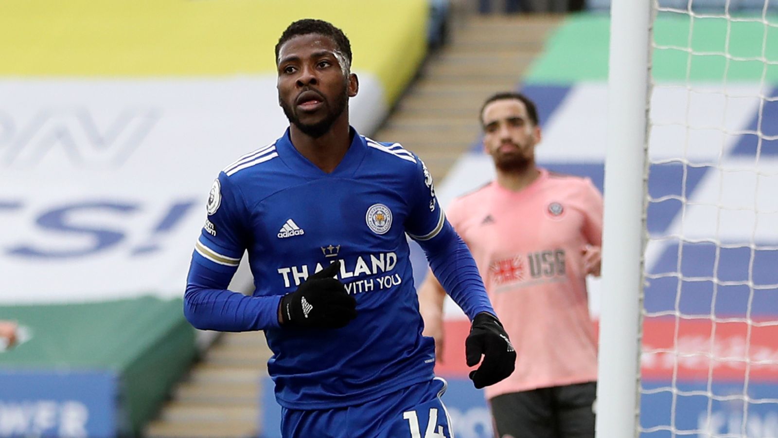  Kelechi Iheanacho is playing soccer for Leicester City wearing a blue jersey with black sleeves and black shorts while looking toward the goal.
