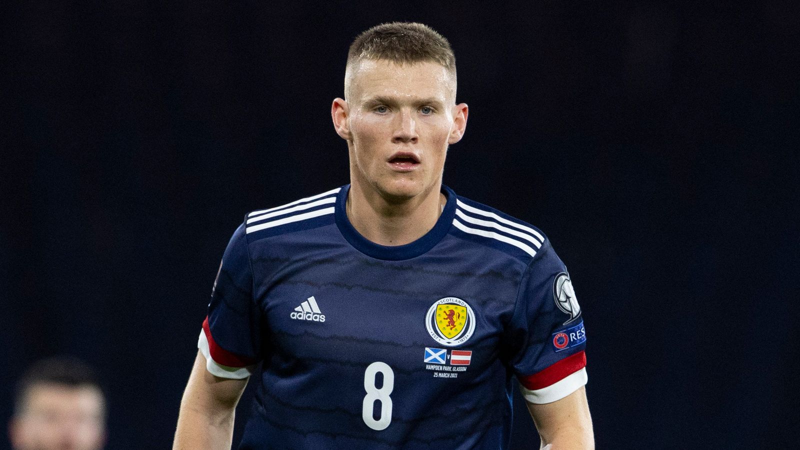  Scott McTominay, wearing a Scotland jersey with the number 8, looking focused during a soccer match.