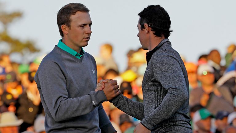 Jordan Spieth, left, shakes hands with Rory McIlroy, of Northern Ireland, on the 18th green during the third round of the Masters