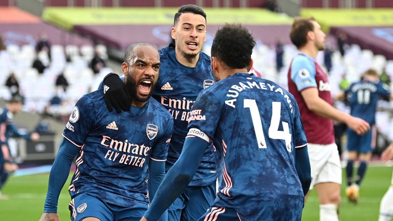 Arsenal's Alexandre Lacazette celebrates with Gabriel Martinelli and Pierre Emerick Aubameyang after scoring their third goal against West Ham