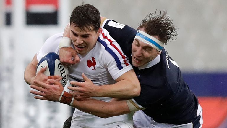 France's Antoine Dupont, left, is tackled by Scotland's Jamie Ritchie