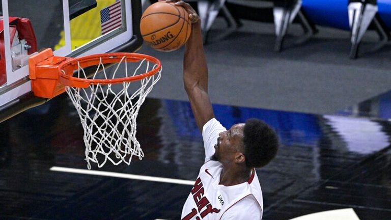 AP - Miami Heat forward Bam Adebayo (13) goes up for a dunk 